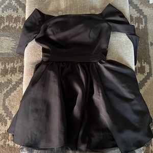 Black off the shoulder dress. With sleeves that go mid way down the arm.